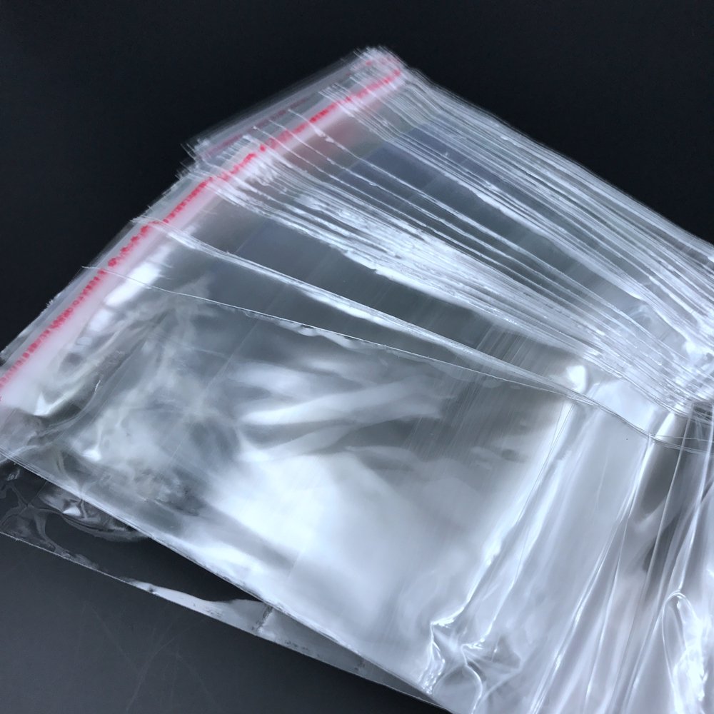 Transparent custom plastic bag packaging with reusable sealing. Transparent plastic polyethylene bag is used for clothing/apparel
